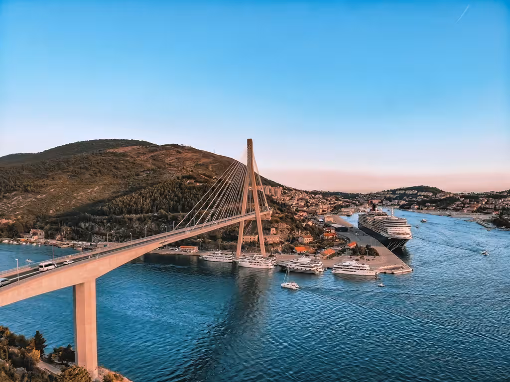 Franjo Tuđman Bridge over Dubrovnik harbor with cruise ships, panoramic highlight on history and scenery tour
