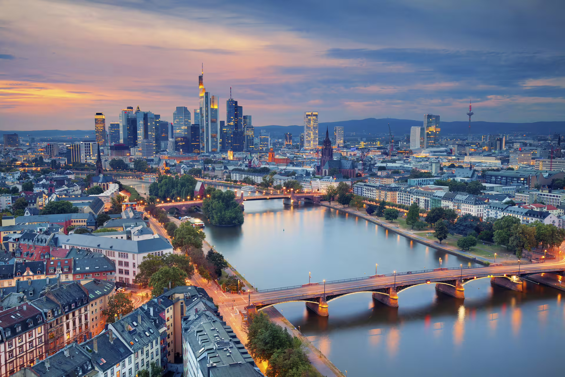 Evening view of Frankfurt am Main skyline and bridges on the Main River, featured in 1-day walking tour audioguide