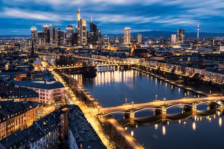 Frankfurt skyline at dusk with illuminated bridges over the Main River and modern skyscrapers