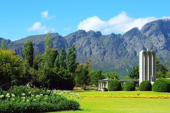 Monumental garden with mountain backdrop in Franschhoek, offering stunning views and cultural heritage.