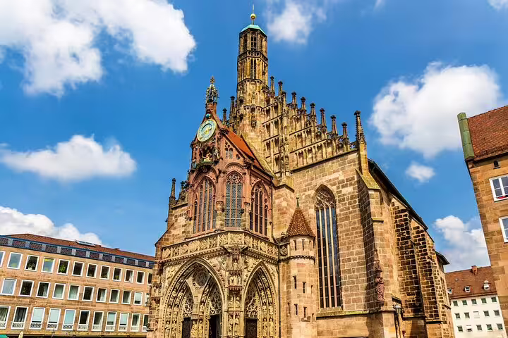 Gothic Frauenkirche church facade with ornate stone carvings and clock tower in Nuremberg's main market square