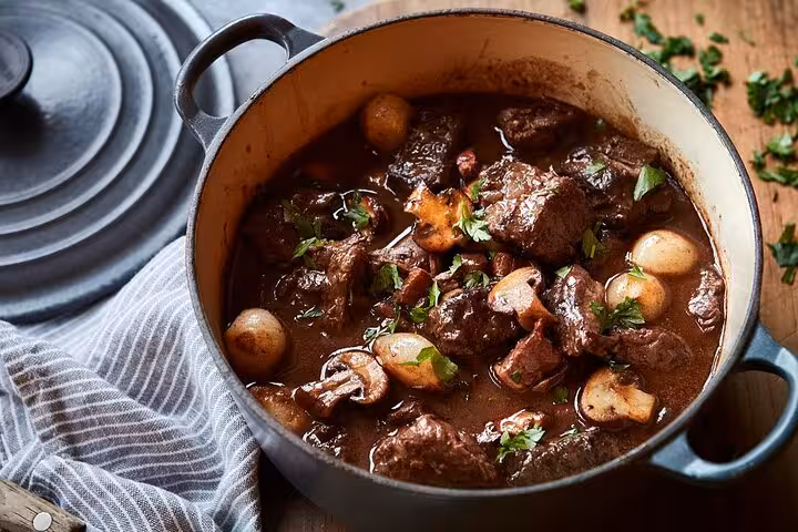 Classic French beef bourguignon with mushrooms and pearl onions in a Dutch oven pot
