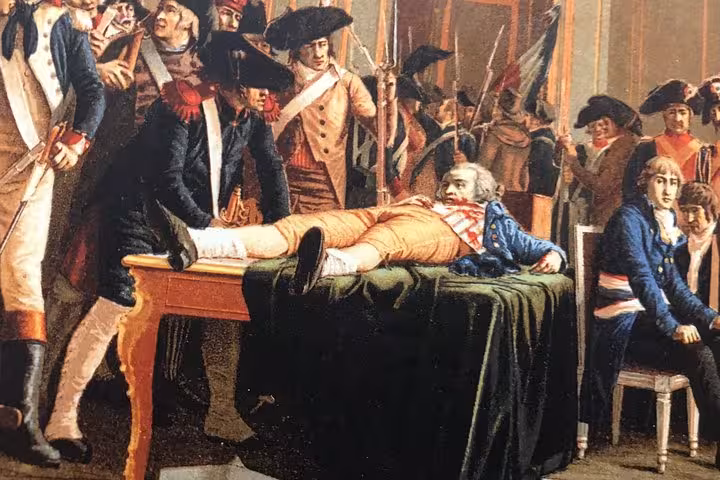 Historical painting of French Revolution scene with soldiers surrounding a wounded man on a table