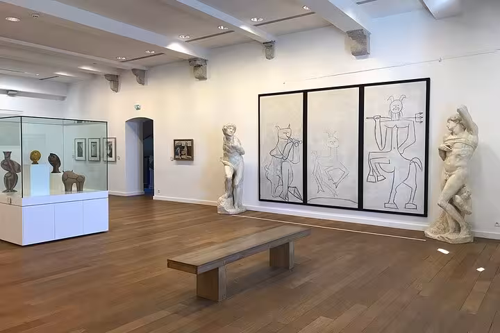 Elegant museum gallery showcasing classical sculptures and contemporary art on the French Riviera tour.