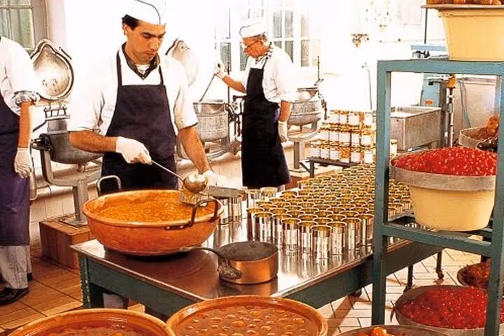Chefs ladling jam into cans at a French Riviera artisan confiture workshop