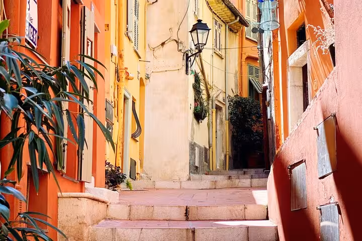 Charming narrow street with colorful buildings in a quaint village on the French Riviera East Coast tour.