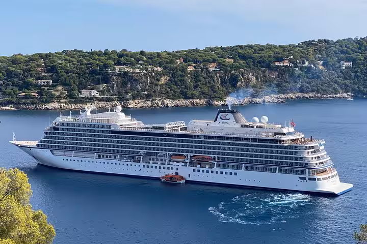 Luxurious cruise ship sailing along the picturesque coastline of the French Riviera.