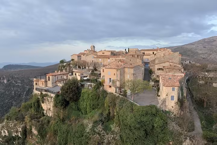 Breathtaking aerial view of a historic French Riviera village perched on a cliffside.