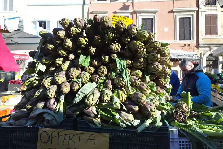 Fresh artichokes piled high at Campo de Fiori market on Rome street food tour near Pantheon