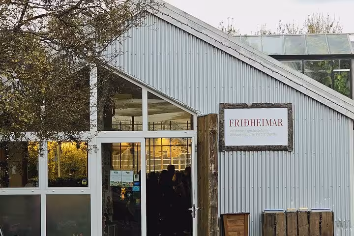 Friðheimar visitor centre entrance with corrugated metal walls on Iceland's Golden Circle route