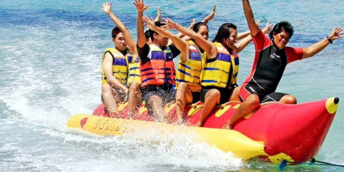 Friends riding a banana boat in Sharm El Sheikh, Red Sea, on a thrilling water sports day trip