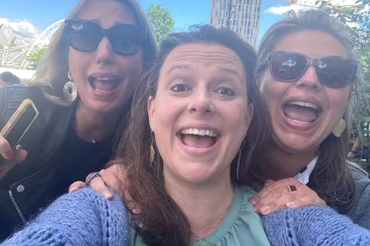 Happy friends selfie on a Madrid e-scavenger hunt, solving clues and exploring landmarks at their own pace