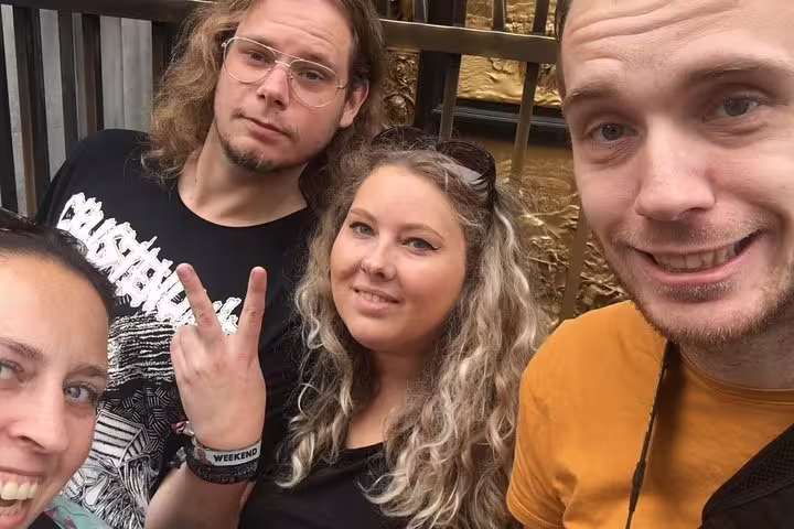 Group of four friends taking a selfie during a walking tour in Florence