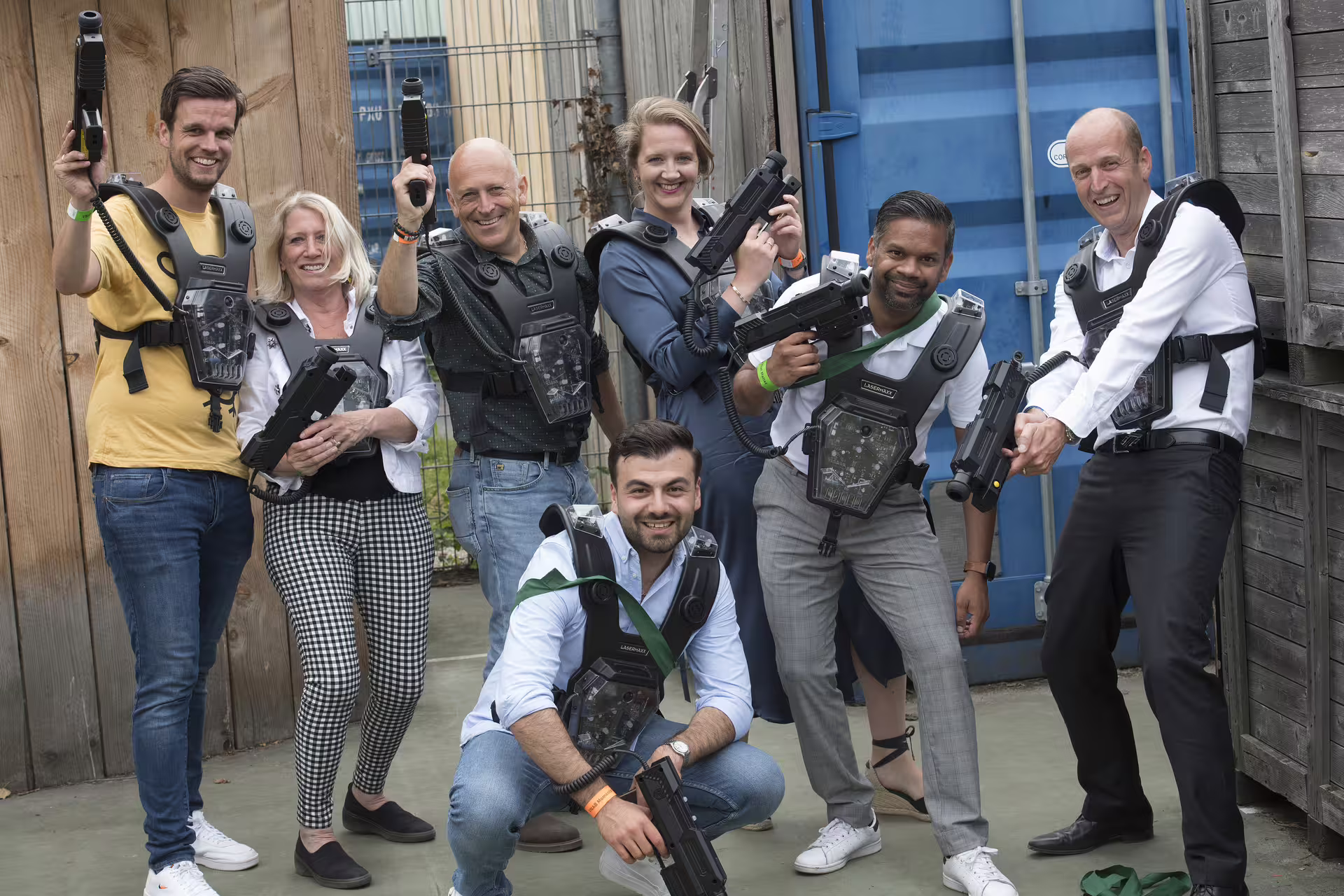 Friends wearing vests and holding blasters at an Amsterdam laser tag arena, perfect for group events
