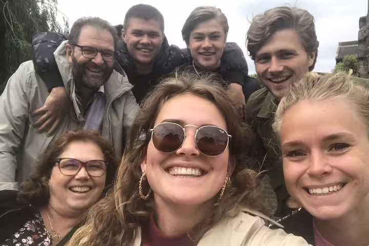 Friends smiling on a Lille city e-Scavenger hunt, team selfie during a fun self-paced walking tour challenge