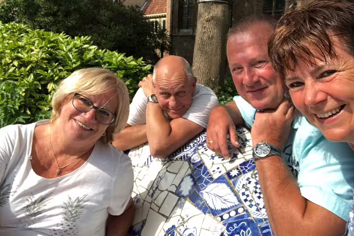Friends take a break during a self-guided Madrid e-scavenger hunt, solving clues in a sunny park