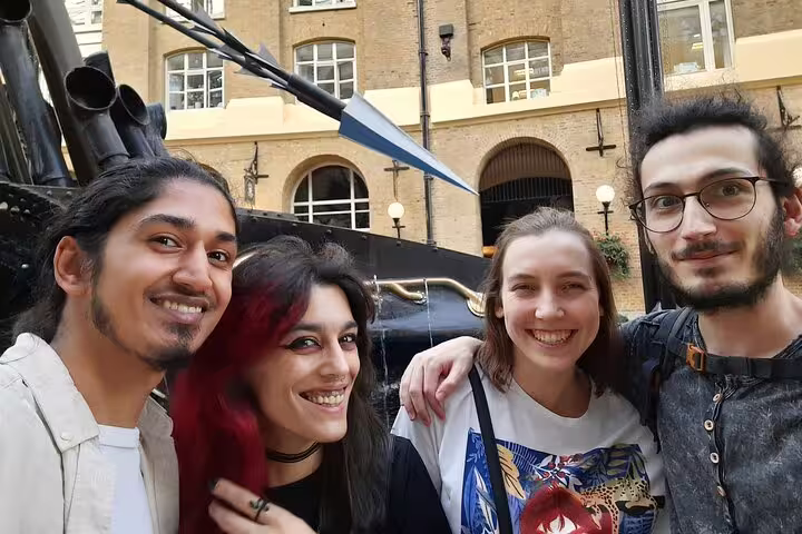 Four friends smiling together on Pirate Walking Tour in Southwark London