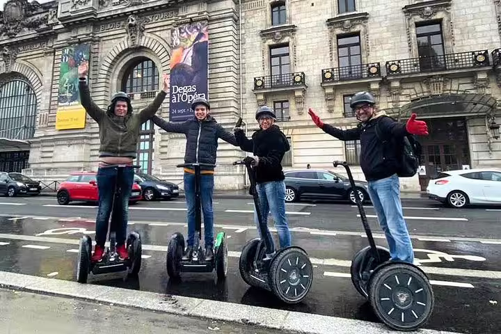 Friends on a guided Paris Segway tour in front of Opéra Garnier, waving on a 3-hour private ride
