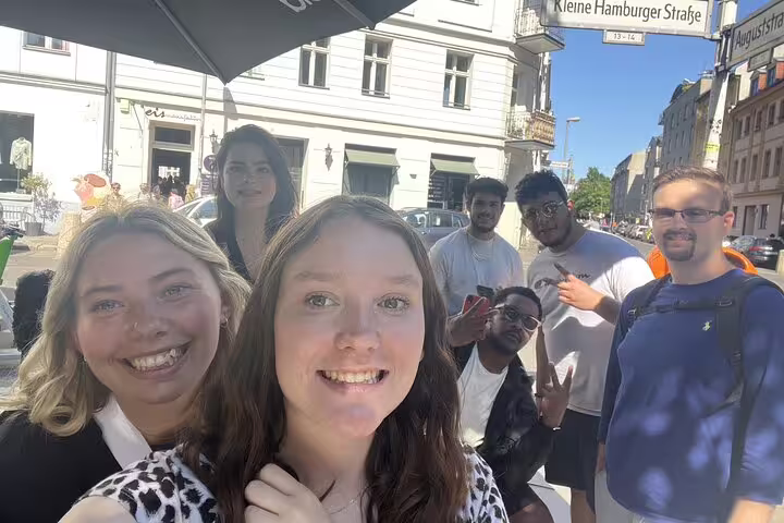 Group of friends smiling at Kleine Hamburger Straße in Berlin during a self-guided exploration tour