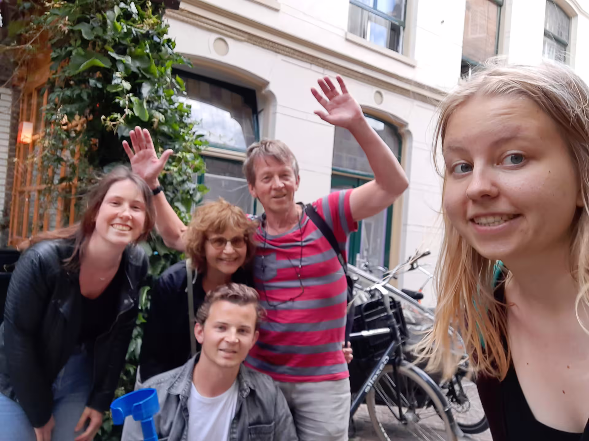 Friends taking a selfie during an Antwerp e-scavenger hunt, exploring hidden streets at their own pace