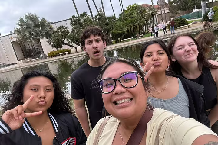 Group of five friends taking a selfie at Balboa Park reflecting pool, San Diego