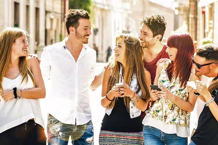 Friends using smartphones on a self-guided Dublin e-scavenger hunt, exploring city streets at their own pace