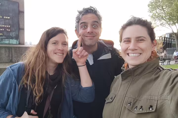 Three friends smiling outdoors during a self-guided walking tour in Greenwich