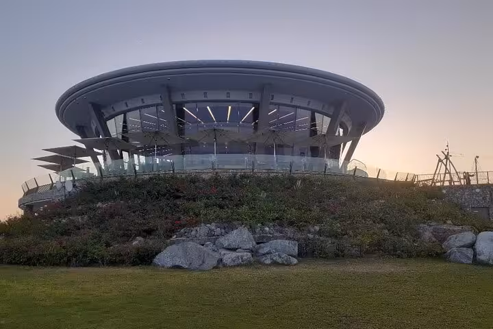 Fujairah mountain safari stop at a modern hilltop viewpoint pavilion near Khorfakkan at sunset