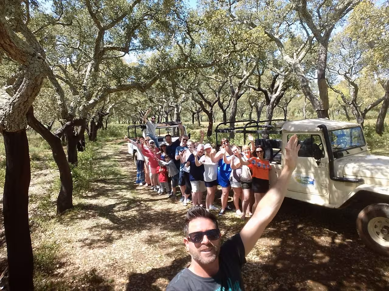 Happy jeep safari group exploring Algarve cork oak forest on a full day off-road adventure tour with local guide