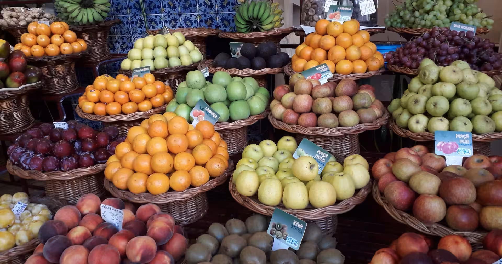 Colorful fruit stalls at Funchal Farmers Market, a cultural stop on a 4-day Madeira tour and levada hike