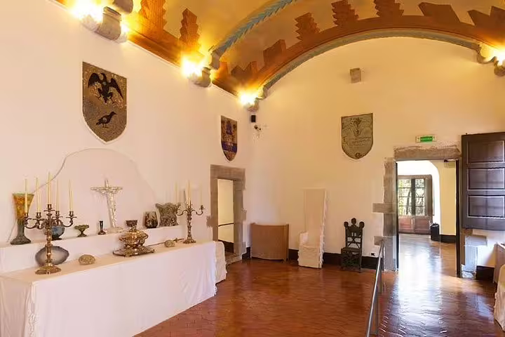 Elegant room in Gala Castle adorned with historic artifacts and shields, ideal for cultural exploration tours.