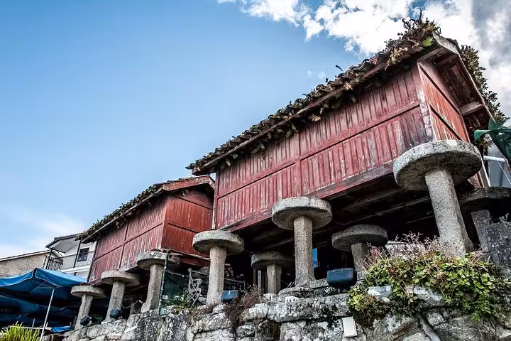 Traditional Galician horreos in Spain, showcasing unique architecture on the Galicia & Portugal tour from Madrid.