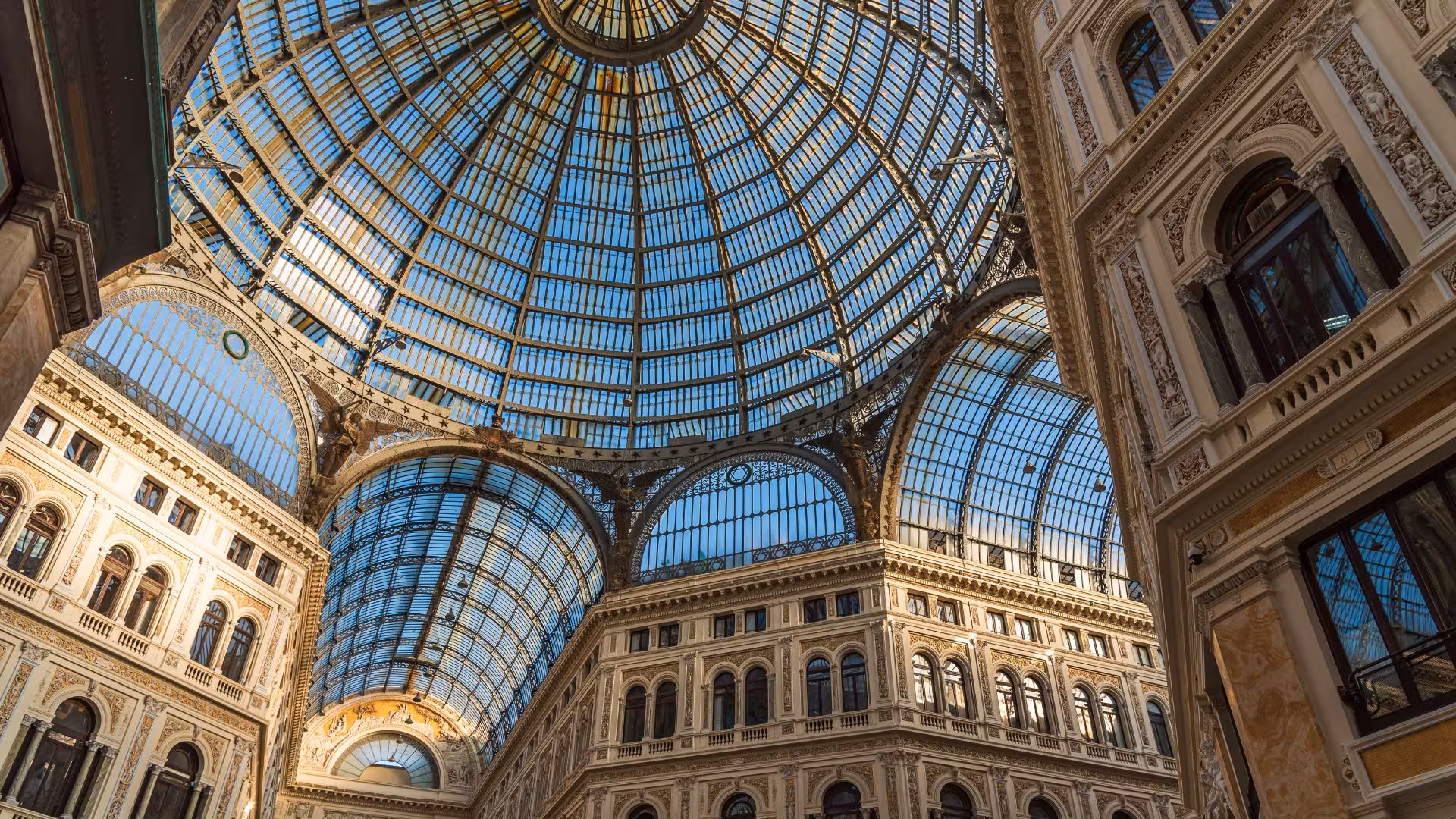 Stunning glass dome of Galleria Umberto I in Naples showcasing intricate architecture and historic elegance.