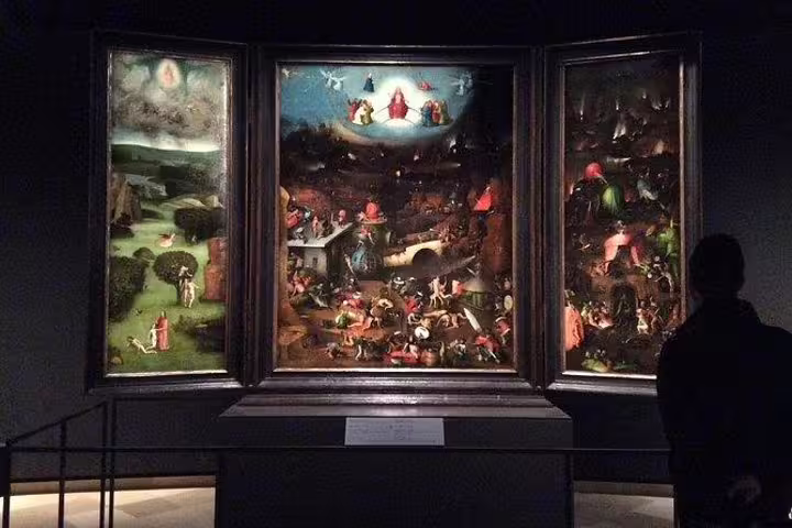Visitor admiring a triptych with vivid medieval scenes at the Gallery of the Academy of Fine Arts.