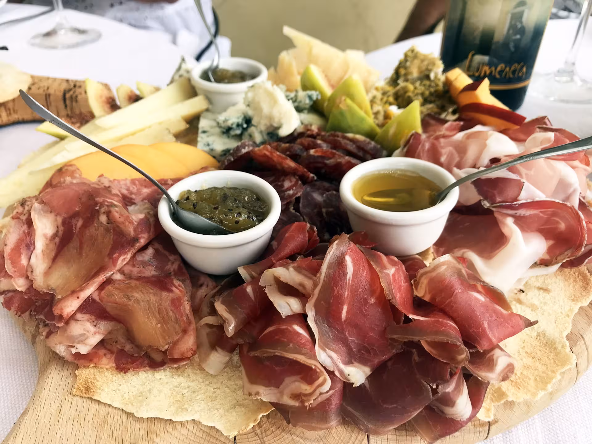 Delicious charcuterie platter with local meats and cheeses, paired with wine at a Gallura winery in Olbia.