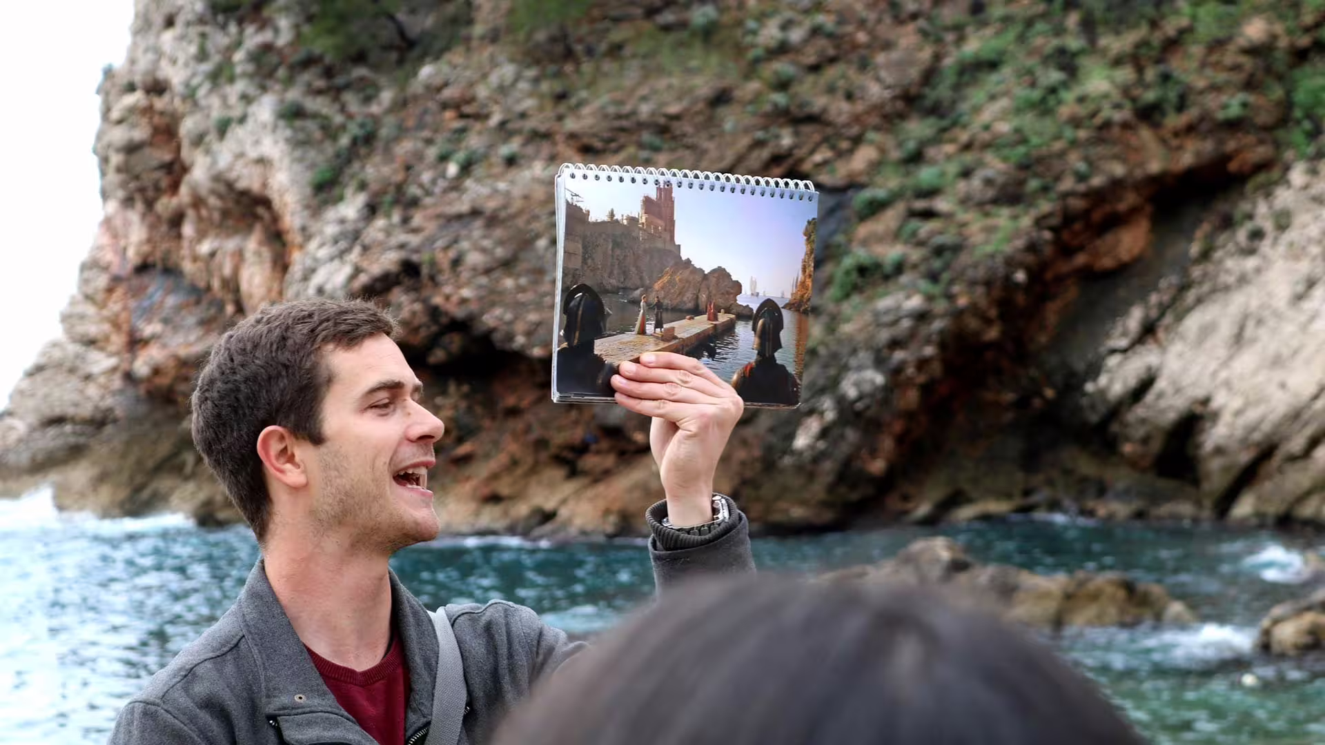 Guide compares Game of Thrones filming photo at Dubrovnik coast on History and Game of Thrones combo group tour
