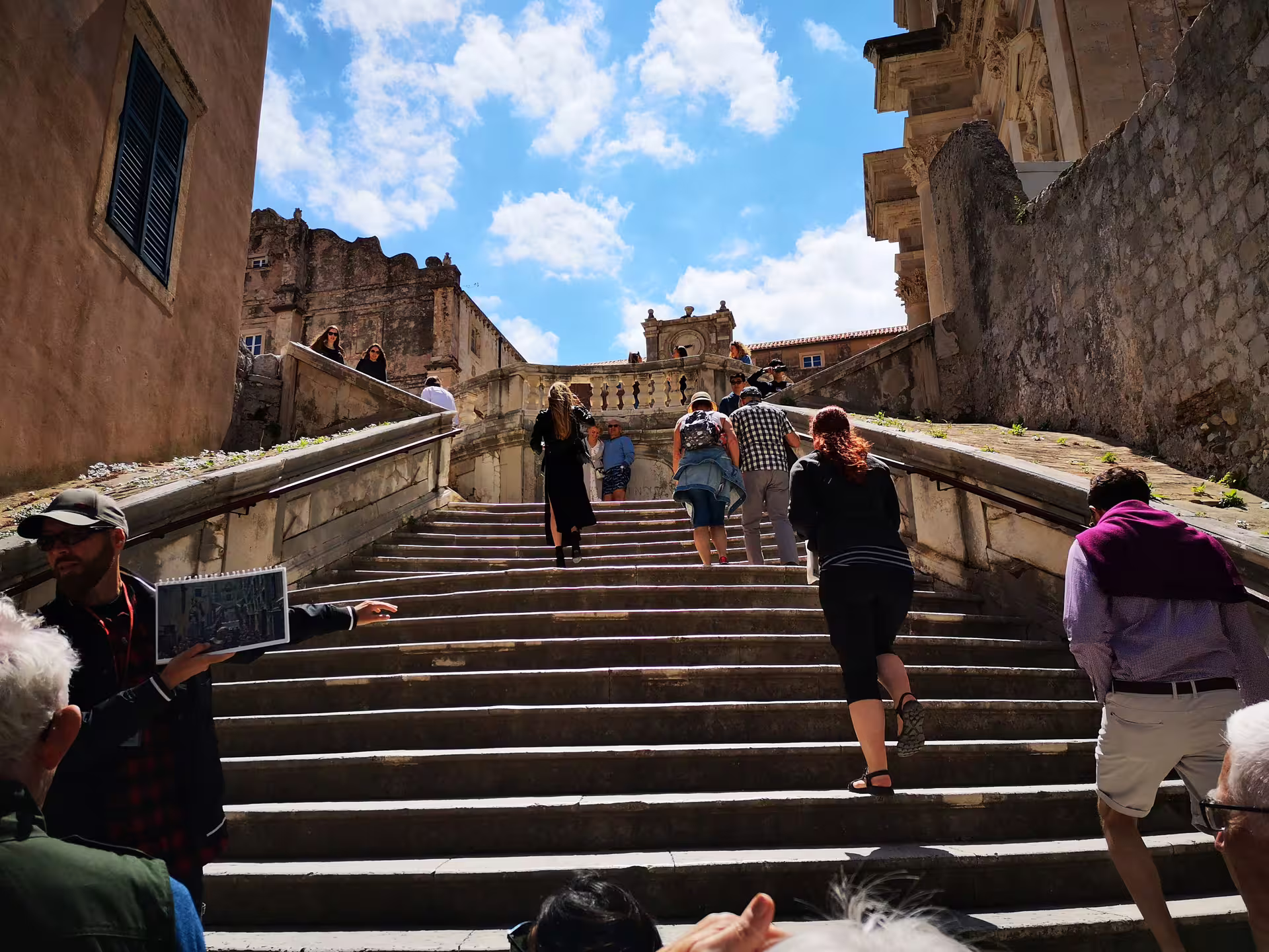 Visitors climbing Dubrovnik Jesuit Stairs on a Game of Thrones walking tour, iconic King’s Landing scene spot