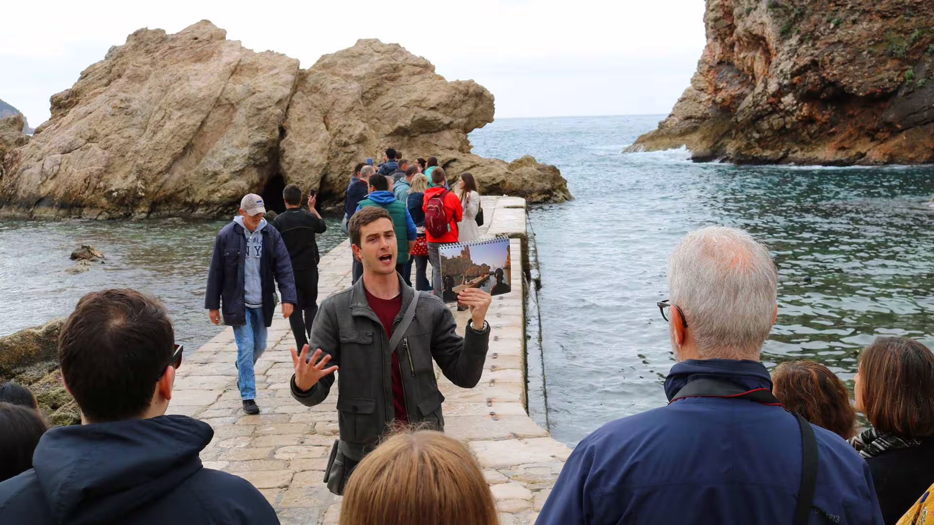 Tour guide explains Dubrovnik Game of Thrones filming locations on a shore excursion by the Adriatic coastline