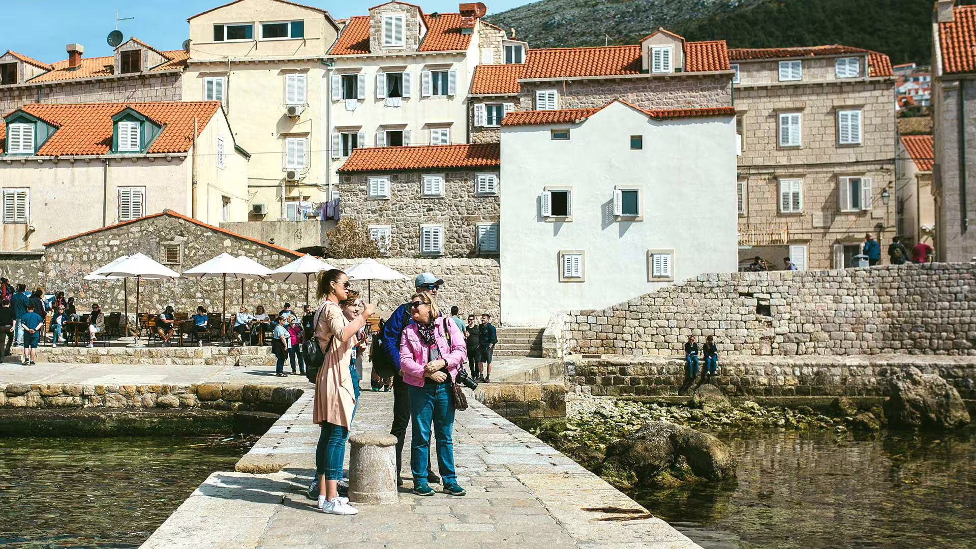 Travelers by Dubrovnik harbor and stone houses on Game of Thrones and history private combo tour in Croatia