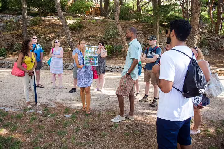 Guide explaining filming locations in a wooded park during the Total Game of Thrones Experience group tour