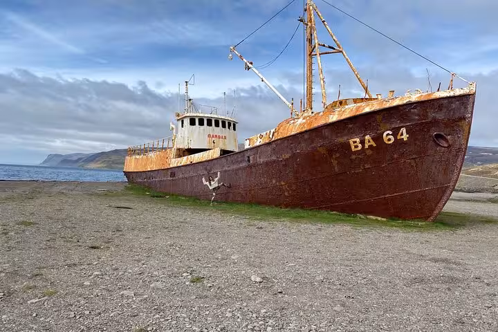 Rusty shipwreck Gardar BA 64 beached on shore in Westfjords Iceland