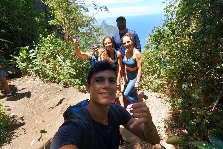 Group of hikers enjoying the lush trail and scenic views during Garganta do Céu hike at Pedra da Gávea, Rio.