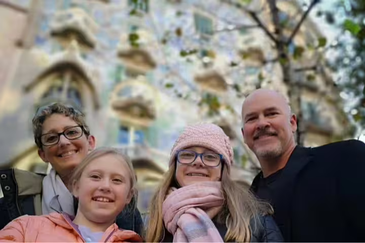 A family enjoys a private tour outside Gaudi's Casa Vicens, highlighting the architectural beauty of La Pedrera, Barcelona.