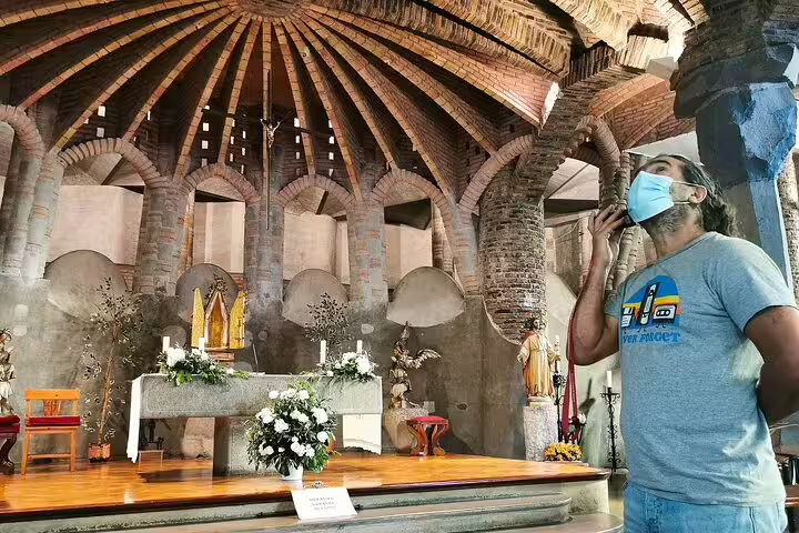 Visitor explores the stunning architecture inside Gaudí's Colonia Güell Crypt on a private skip-the-line tour in Barcelona.