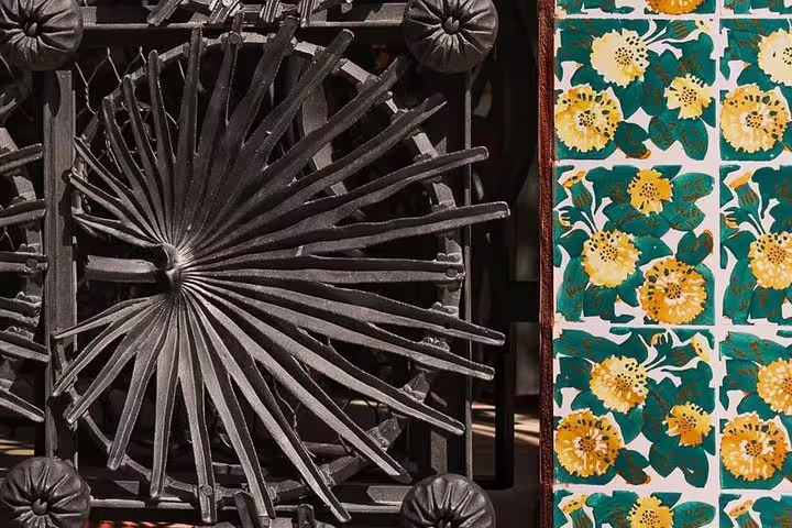 Intricate wrought iron design and vibrant floral tiles at Gaudi's La Pedrera and Casa Vicens, Barcelona private tour.
