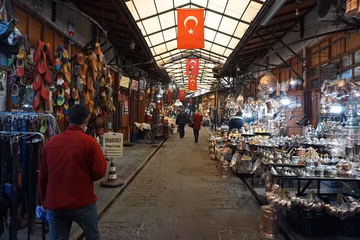 Gaziantep historic bazaar corridor with Turkish flags and copperware stalls on private guided tour