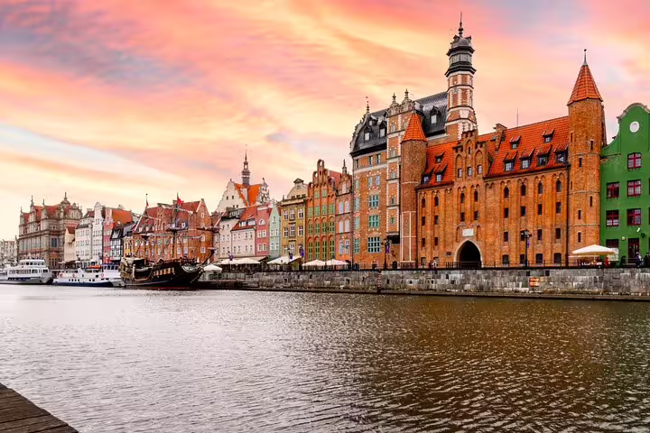Motlawa River waterfront and Crane in Gdansk Old Town at sunset on a self-guided scavenger hunt tour