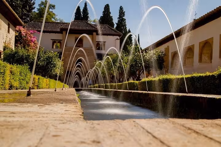 Elegant fountains in Generalife Gardens, Alhambra, Granada, offering a serene glimpse into Moorish architectural beauty.