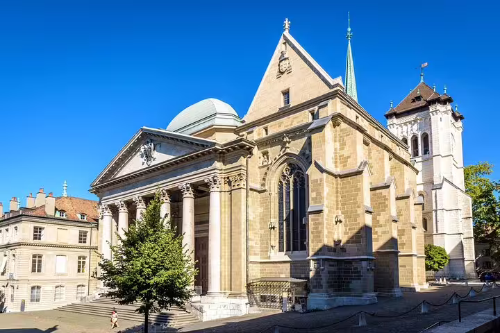 St. Peter's Cathedral in Geneva's old town, a historic Gothic and Neoclassical church under blue sky