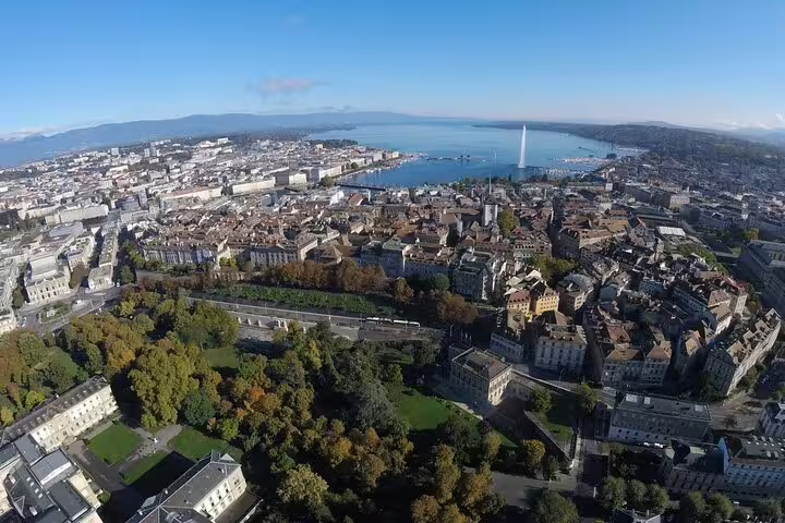 Aerial view of Geneva city with Lake Geneva and Jet d'Eau fountain visible on a clear day